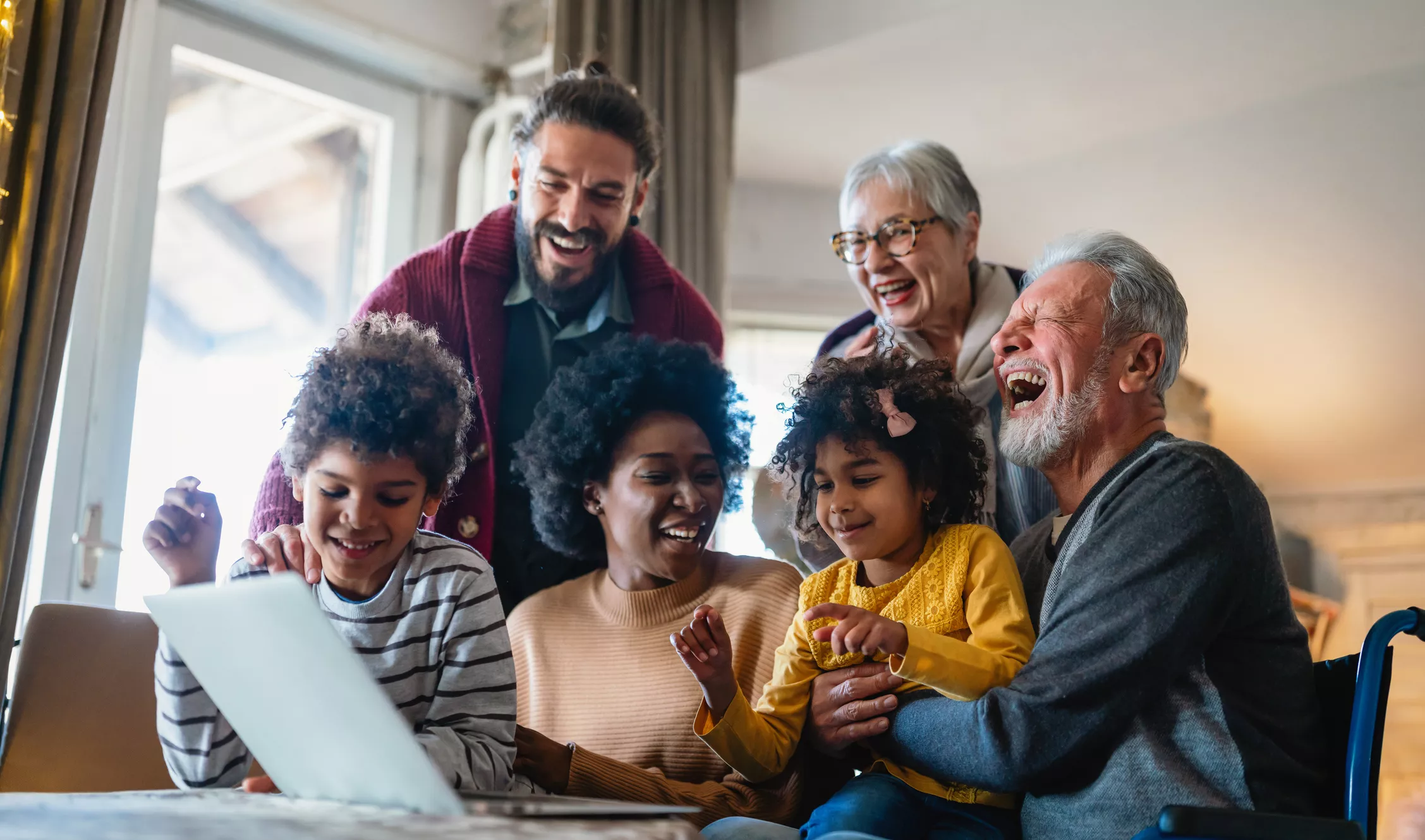 Mixed multigenerational family laughing and chatting