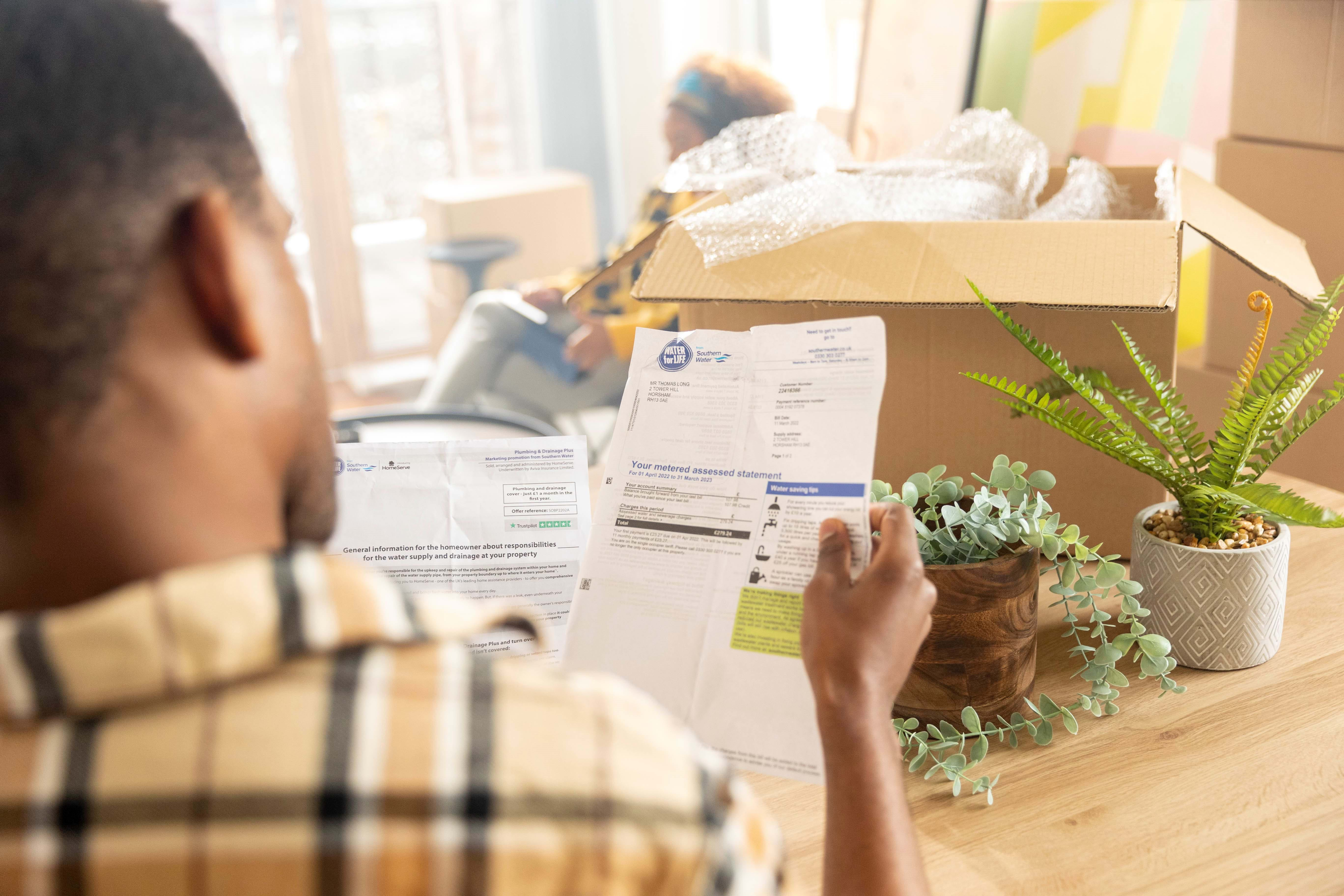 Man holding a utility bill in his hand