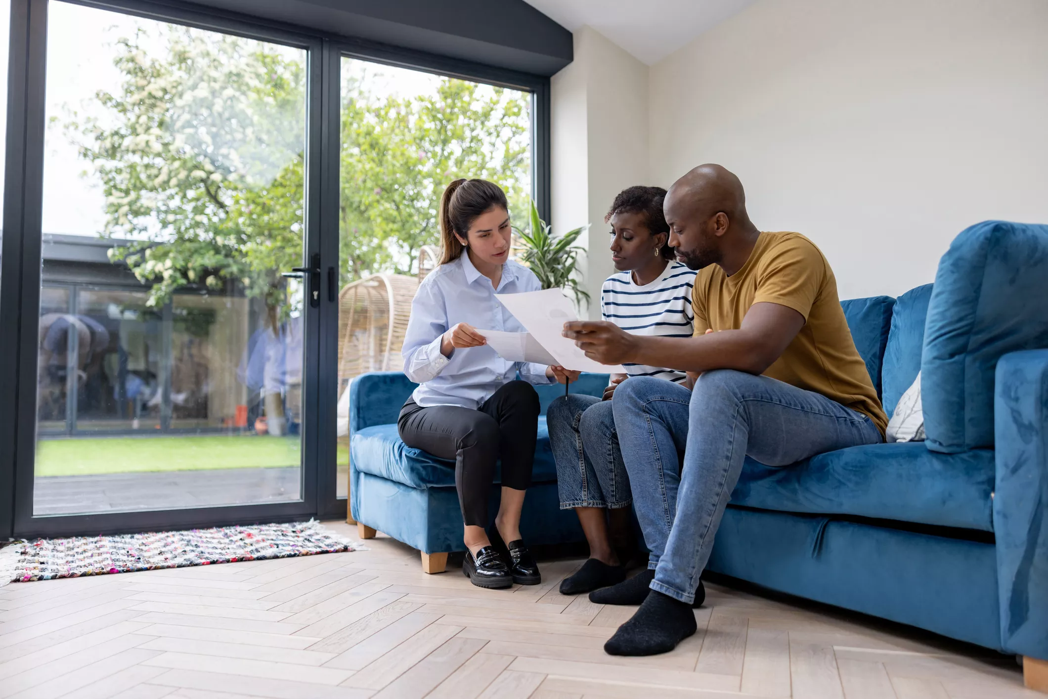 Couple reviewing documents with an estate agent