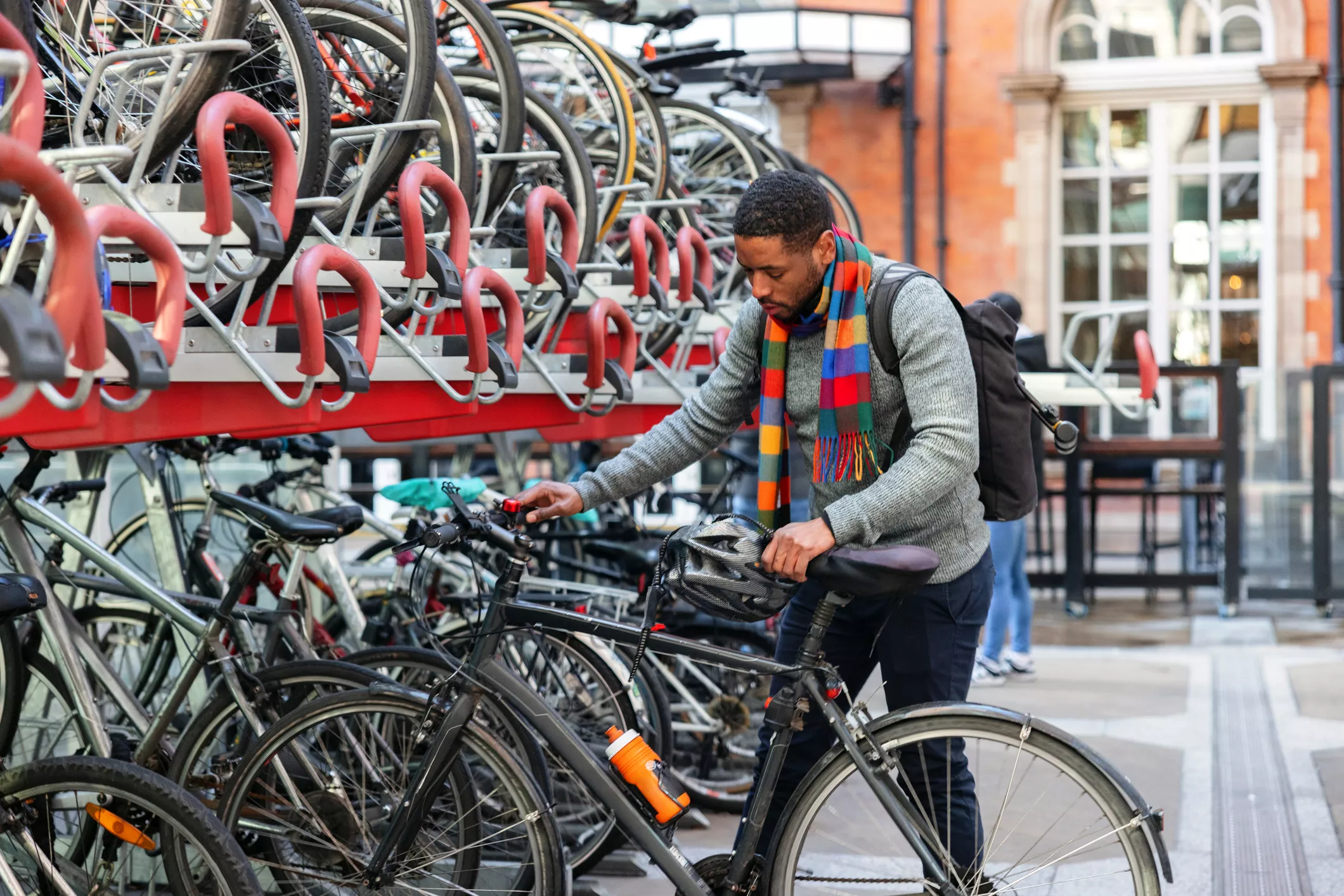 man storing bike into dedicated cycle storage