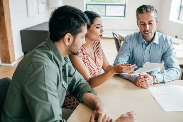 A couple is discussing options with a mortgage advisor